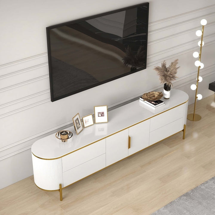 Modern white tv stand with gold-finish legs, handles and a marble top in living room