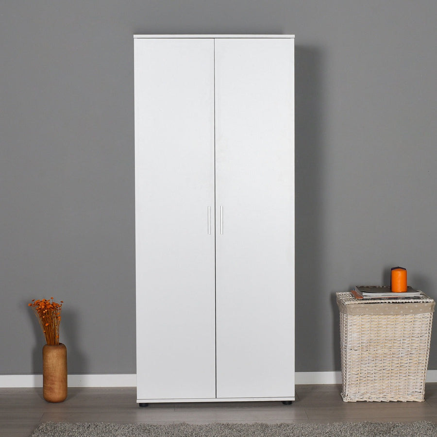 White modular wardrobe design against a gray wall with decorative items on the floor.