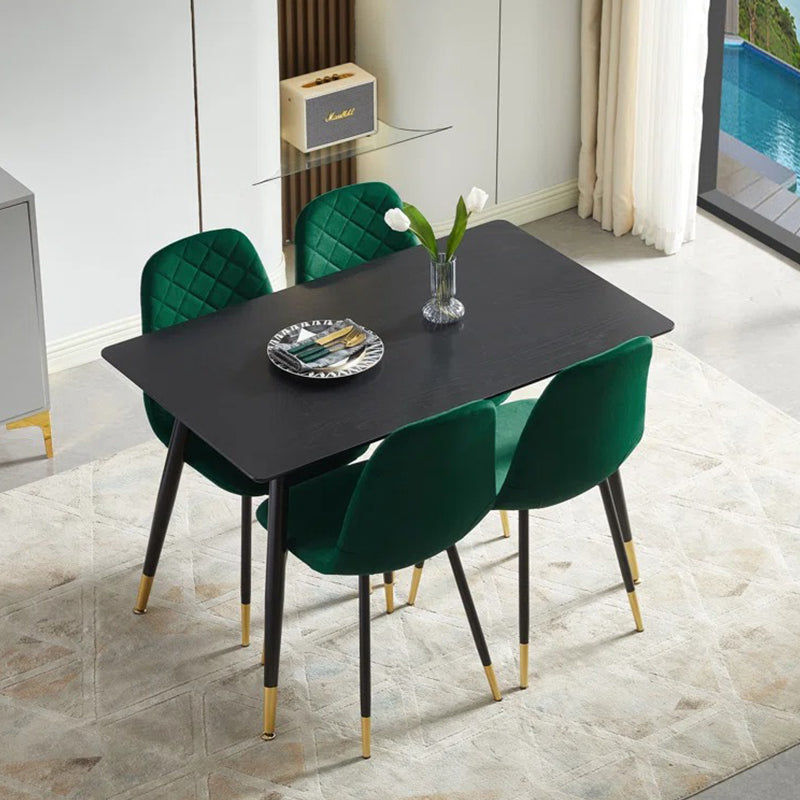 stylish dining table is supported by four powder-coated black metal legs and four ergonomically designed dining chairs upholstered in high-quality fabric