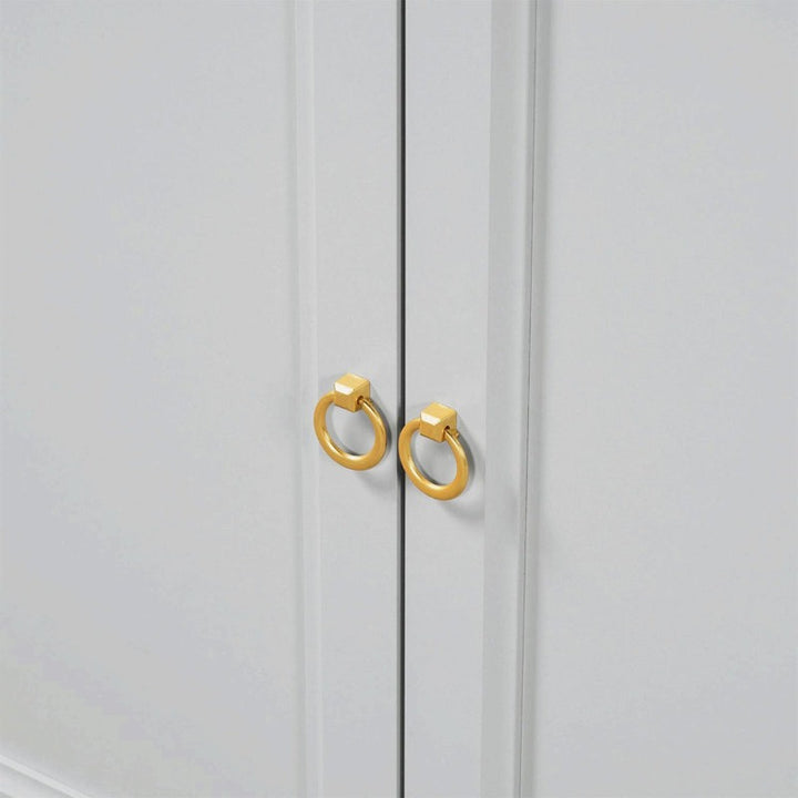 golden handles of a grey-finish sideboard