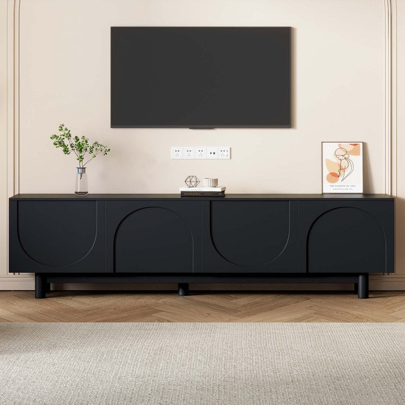 A black Halo TV stand with an elegant design, featuring arched doors and sleek legs, with a television and decorative items on top.