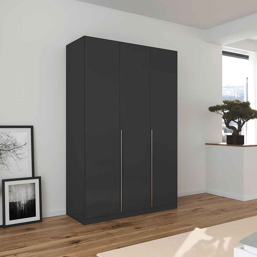 A matte black 3-door wardrobe with integrated handles, six shelves, and two hanging rods inside, placed in a room with minimal decor.