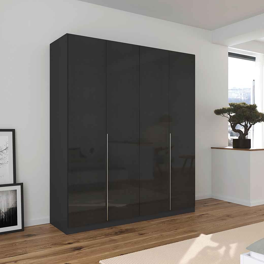 A glossy black 4-door wardrobe with handle-less doors, situated in a modern room setting with a minimalist design.