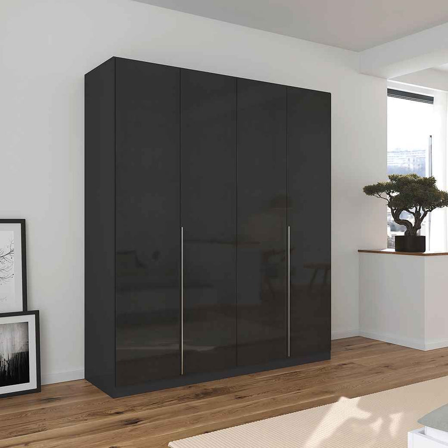 A glossy black 4-door wardrobe with handle-less doors, situated in a modern room setting with a minimalist design.