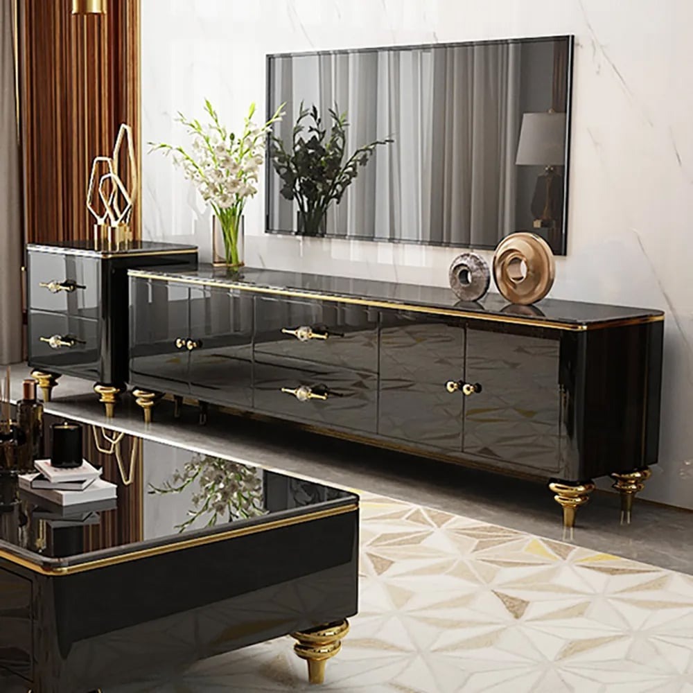 A premium black TV stand with a faux marble top, gold-finish handles and legs, storage compartments, and a flat-screen TV on top.
