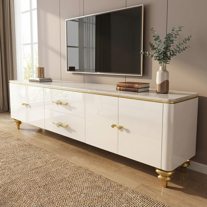 White entertainment console with gold accents and marble top in a living room setting.