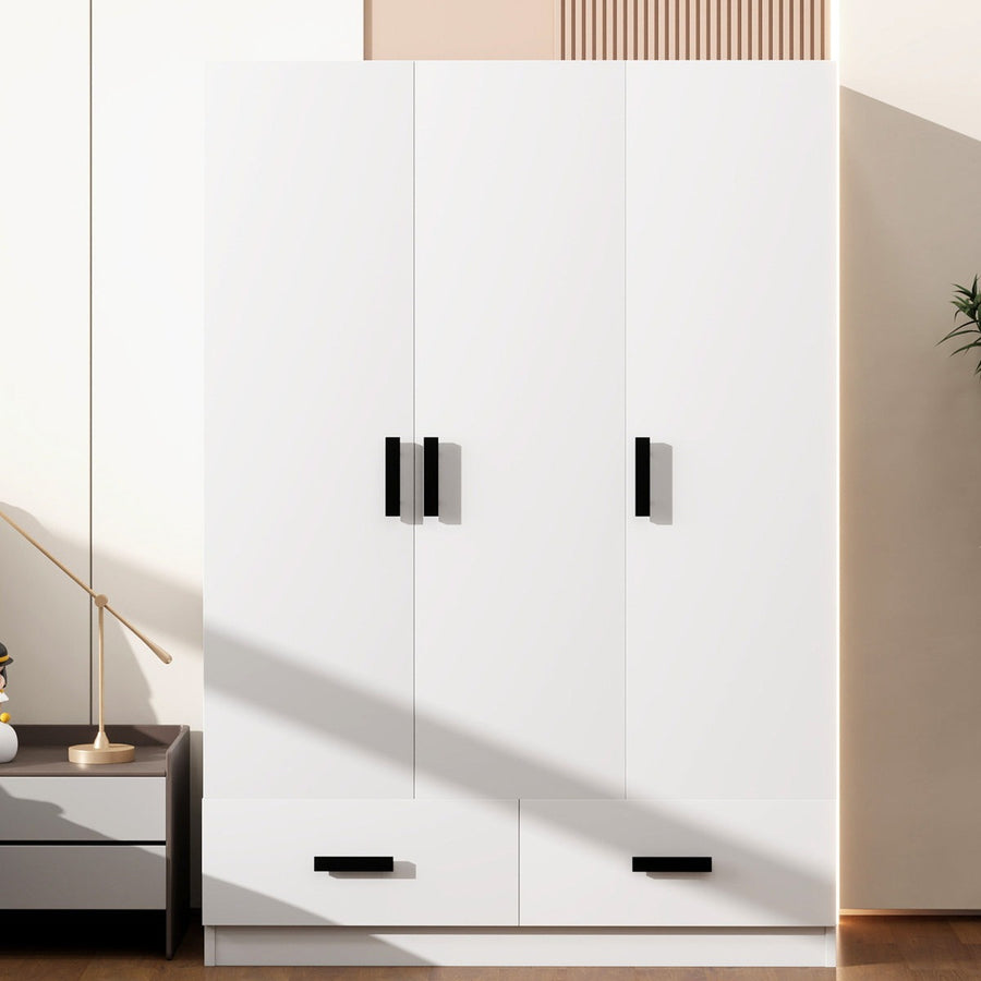 White modular wardrobe with black handles in a modern room setting