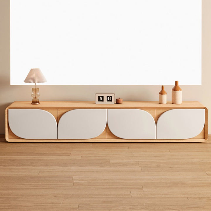 A modern Lotus TV unit made of rubber wood with a high-gloss finish, featuring a spacious countertop and four push-to-open drawers, displayed in a room setting with decorative items on top.