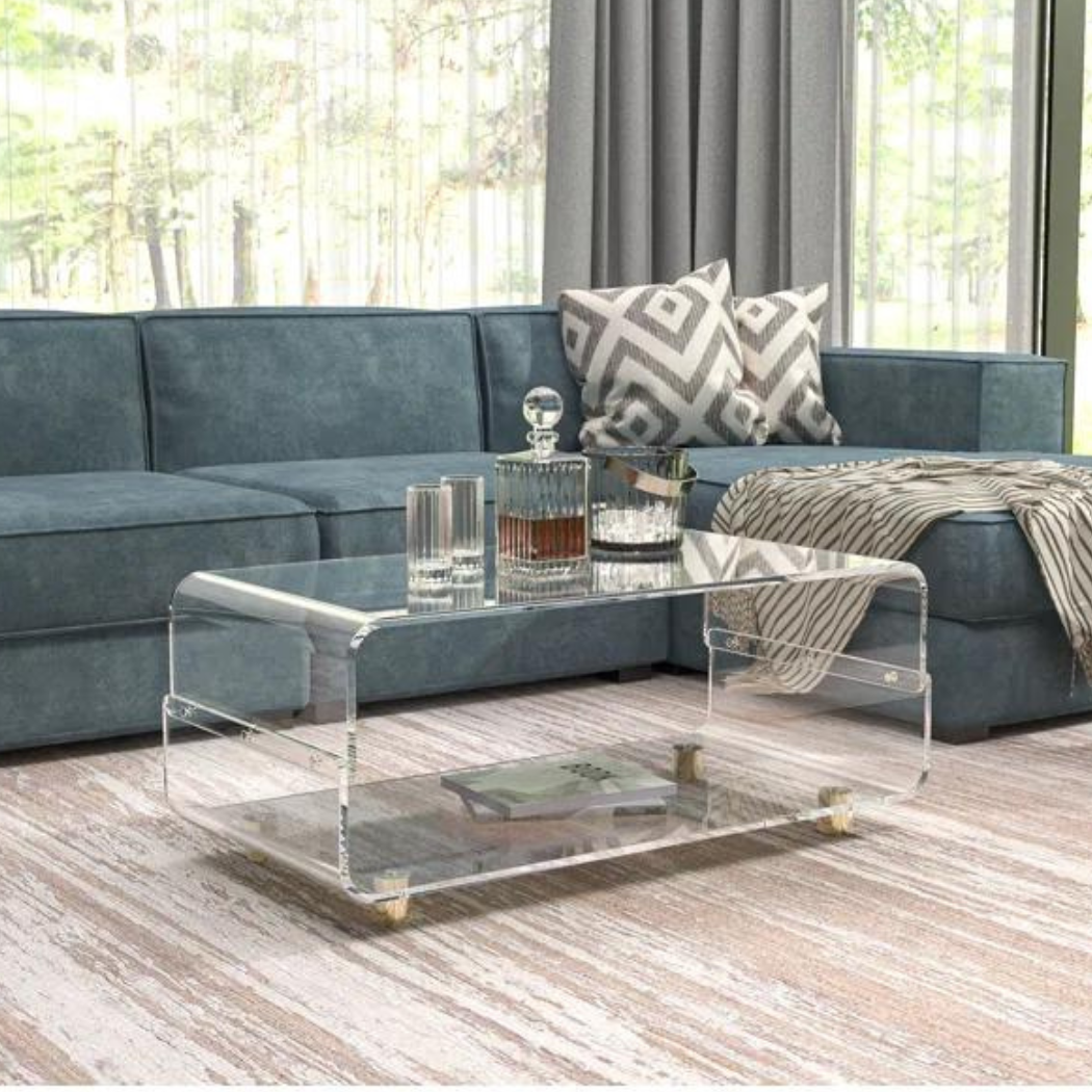 Clear acrylic coffee table with 2 tier storage with blue sofa set in a living room