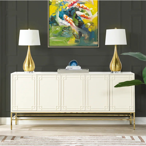 White sideboard cabinet with gold accents and handleless doors by Heera Moti