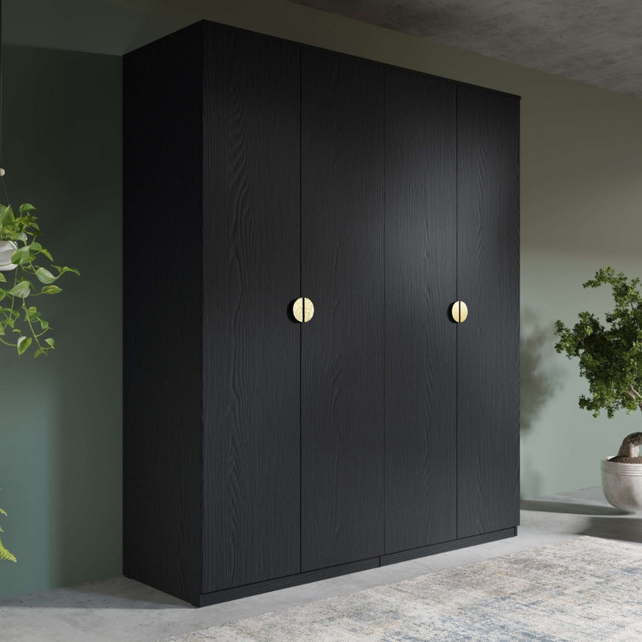 A matte black 4-door wardrobe with golden round handles.