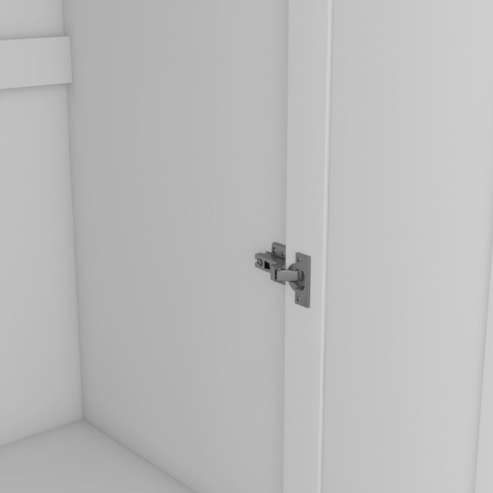 Close-up of a metallic hinge on a white wardrobe