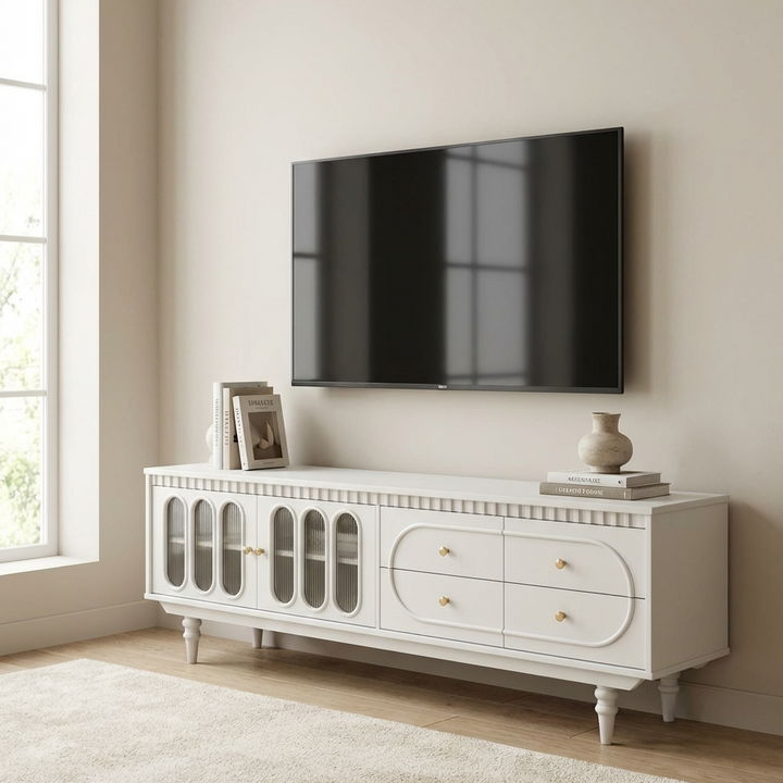 A white TV stand with a television mounted on a beige wall in a room with a window.