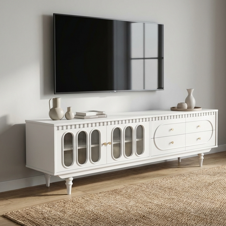Luxury white tv stand with decorative items in a room with a television above.