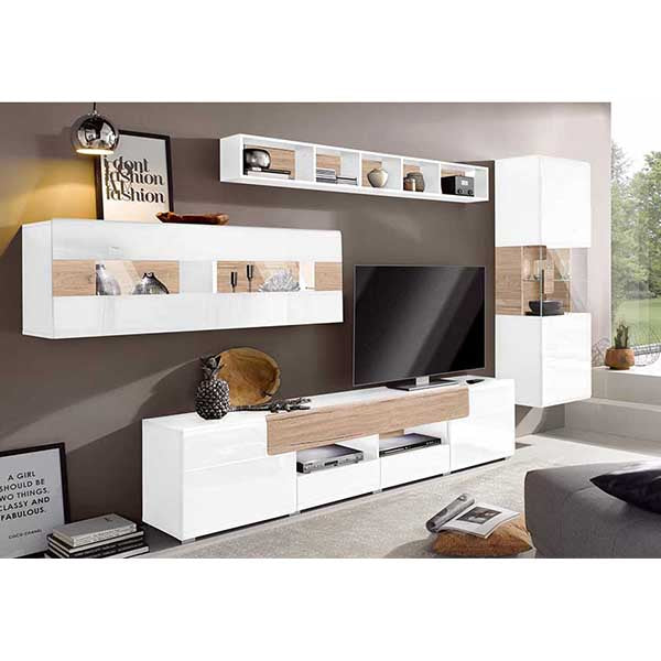 A modern white and beige TV unit set with multiple shelves, drawers and a flat-screen TV, placed in a room with decorative items and a bookshelf in the background.
