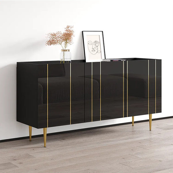 A sleek black sideboard with golden metal legs, featuring soft-close operable shutters, is placed in a room with a vase with flowers on top.