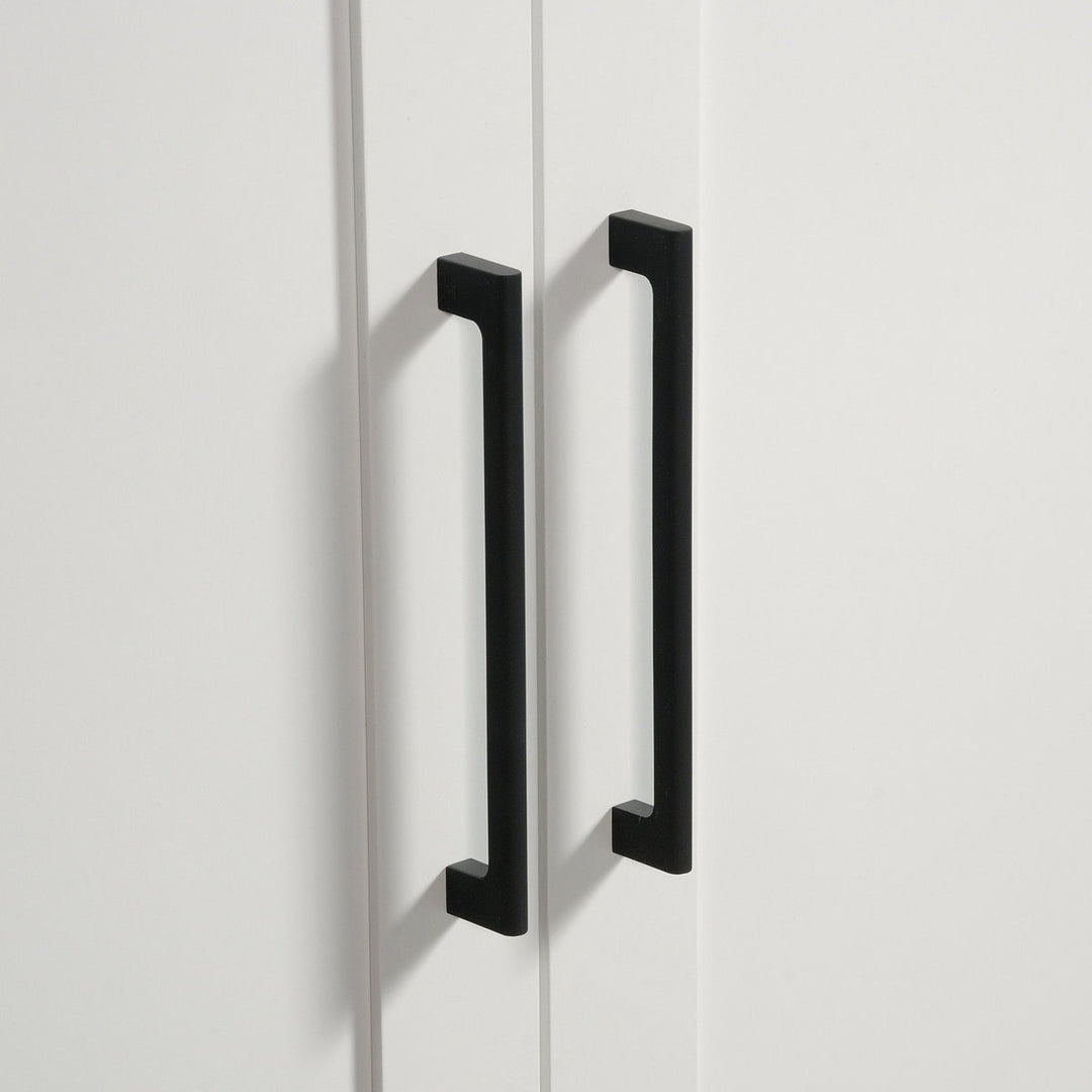 Black cabinet handles on a white cabinet door