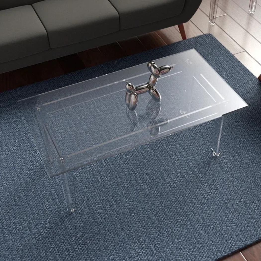 Stylish transparent coffee table with decorative piece on top