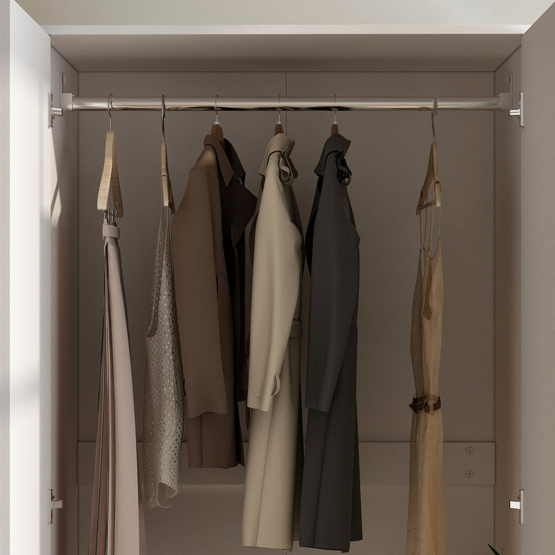 white 2-door closet with hanging clothes, including a beige coat, brown jacket, and other garments.