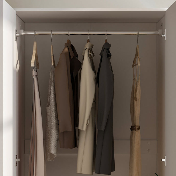 white 2-door closet with hanging clothes, including a beige coat, brown jacket, and other garments.