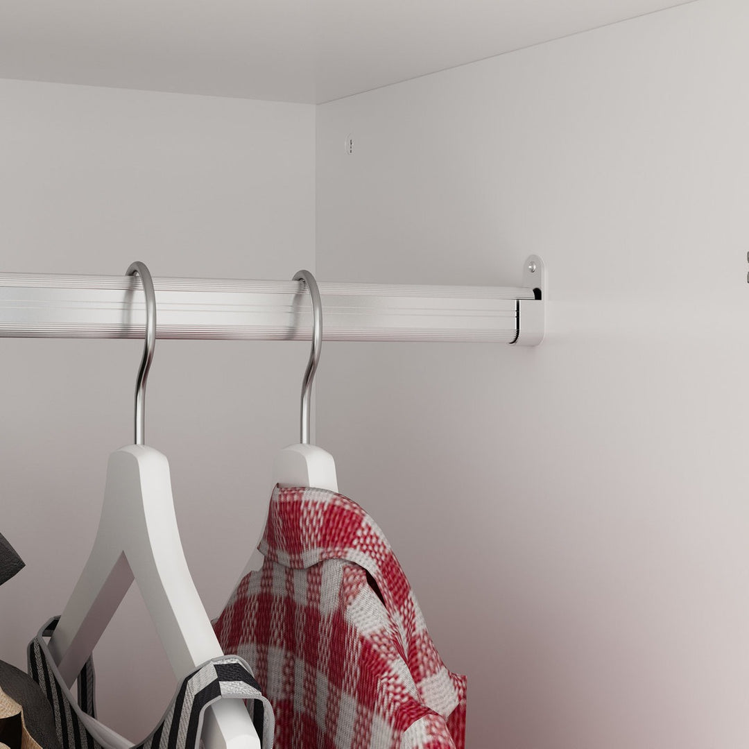 White hangers with a red and white checkered shirt on a metal rod against a white wall.