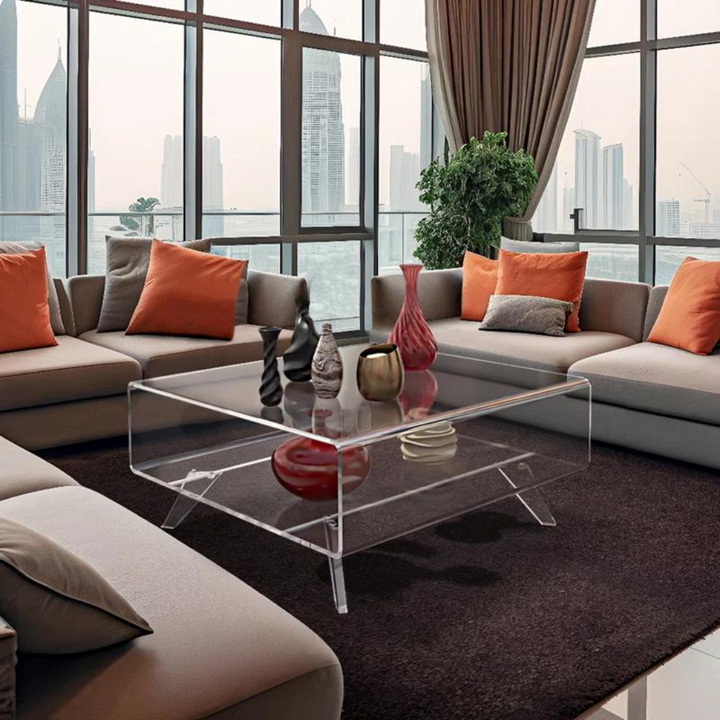 Clear coffee table in living room with light-colored sofa set
