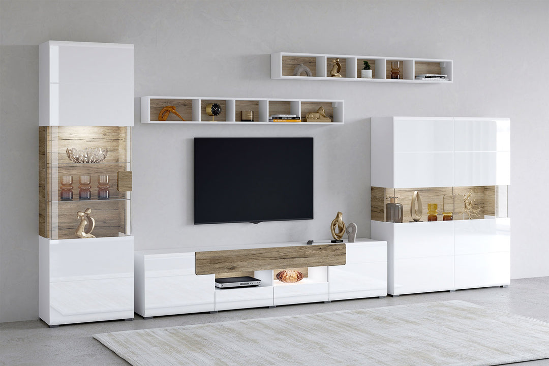 Modern living room setup with white wall unit, premium white and beige TV unit set with TV, and decorative items.
