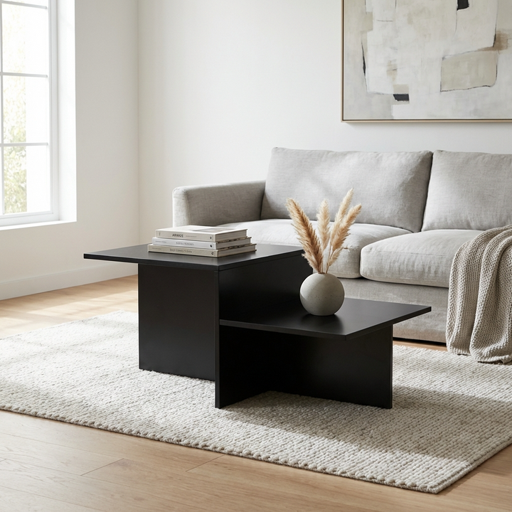 Modern living room with a small black coffee table with 2-tier storage, grey sofa, and decorative elements.