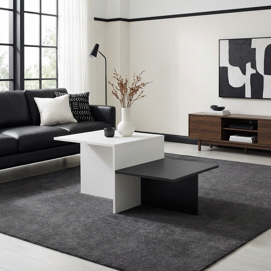 Modern living room with a black and white coffee table, a black sofa, and abstract art on the wall.