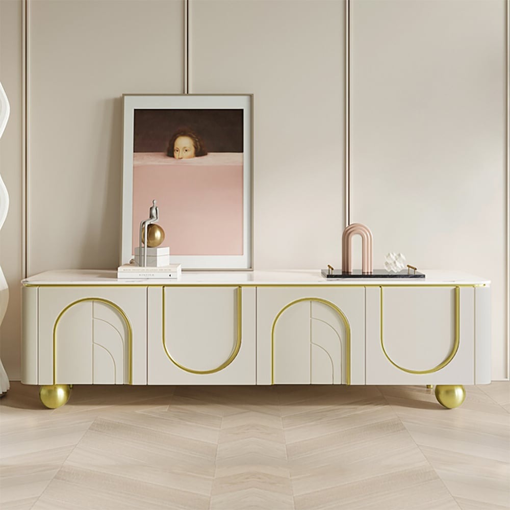 A modern white TV stand with an arch design and gold accents, featuring a marble top and storage spaces, set against a room with a light color scheme.