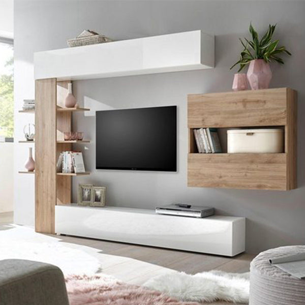 A modern TV unit with a white and beige color scheme, featuring a flat-screen TV, magazines, books, and decorative items on the shelves.