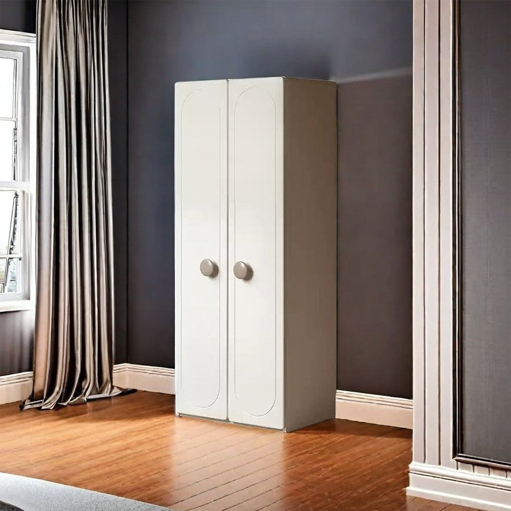 Stylish white wardrobe with silver handles against a dark wall in a room with wooden flooring.