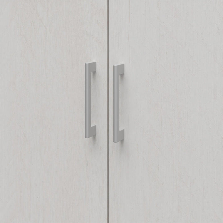 Close-up of a light grey wardrobe with metallic handles on a white background