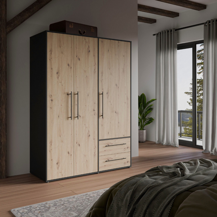 A 3-door wardrobe with beech/ black finish, featuring two drawers and multiple shelves in a room with a large window.