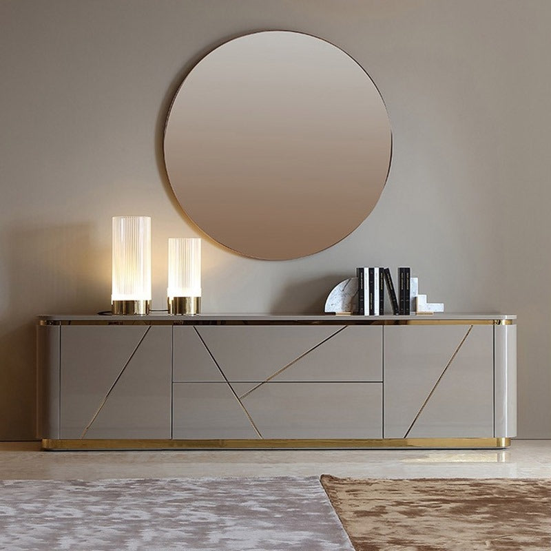 The grey TV stand design with gold accents offers ample storage. 