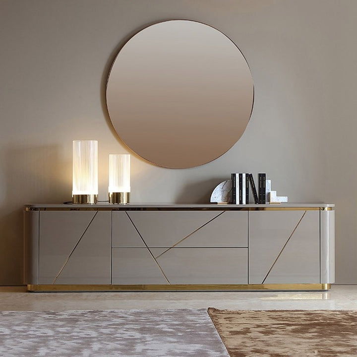 The grey TV stand design with gold accents offers ample storage. 