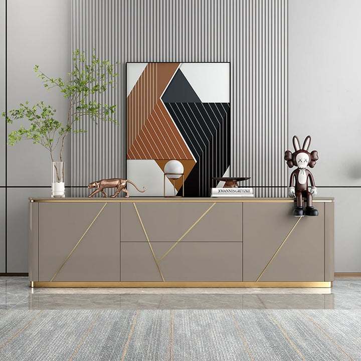 Stylish grey tv stand with decorative items on top placed against a grey wall