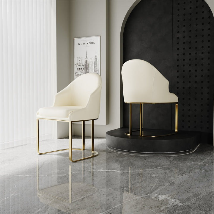 Modern white chairs with gold legs in a stylish interior.