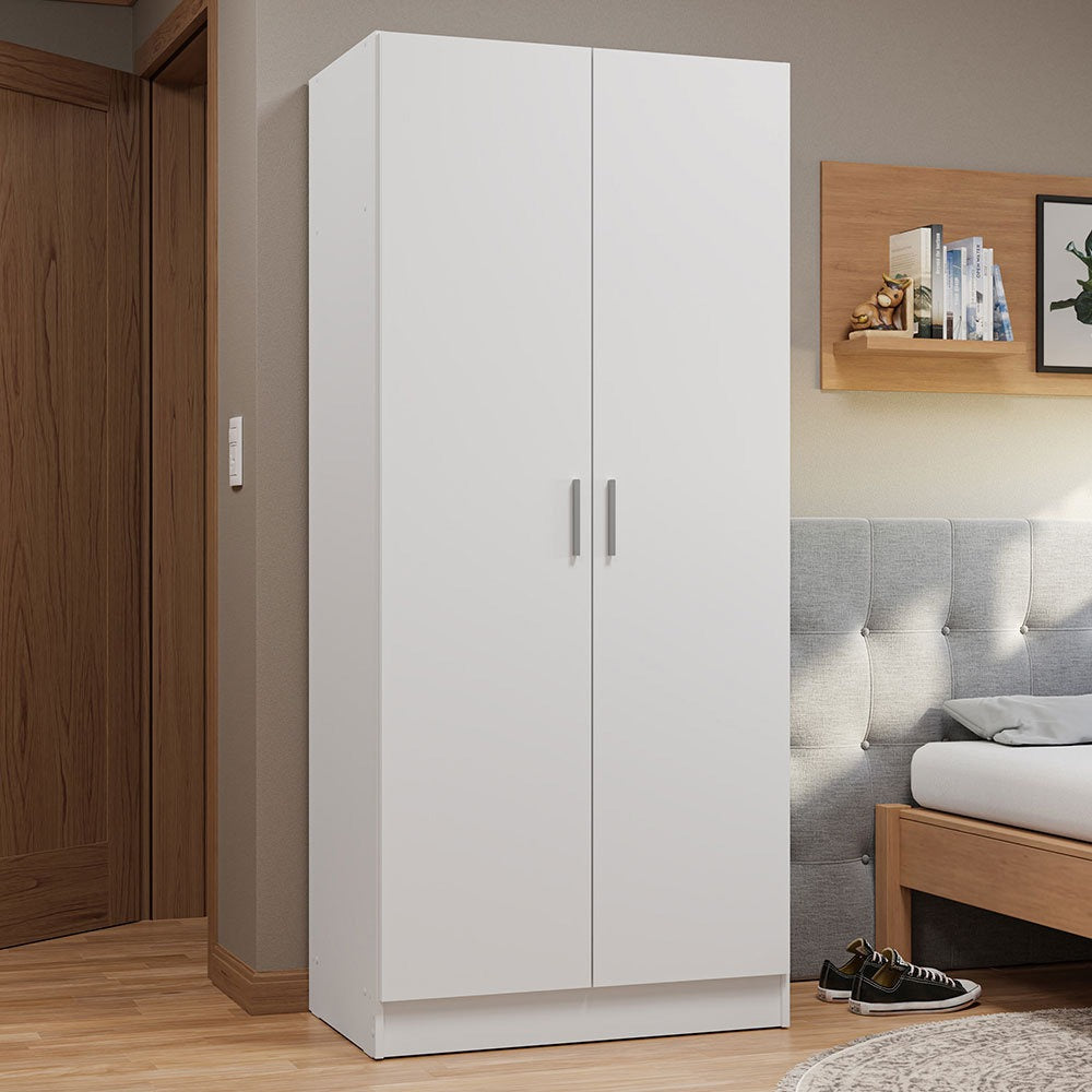 A white pre-laminated wardrobe in a bedroom setting with a bed and wooden shelf in the background.
