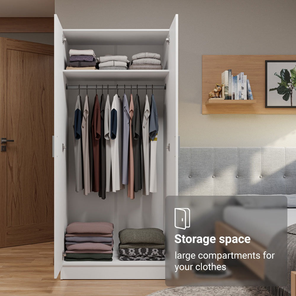 White closet with clothes and storage compartments in a bedroom setting