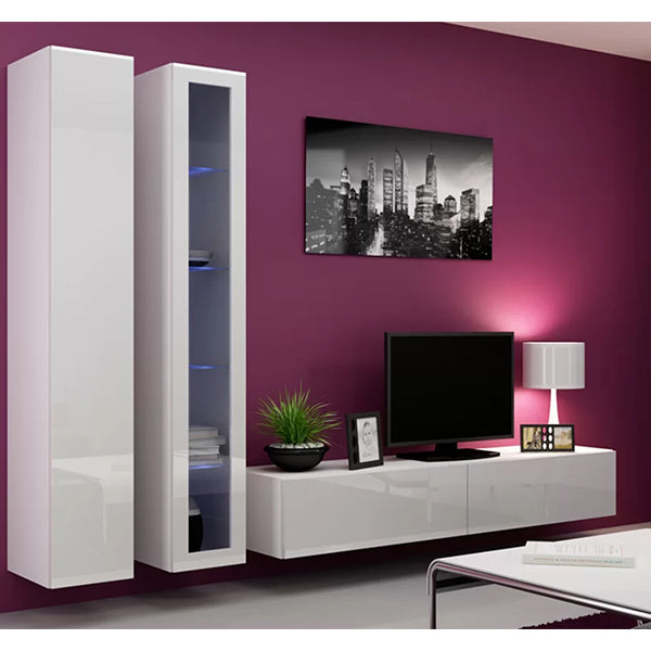 A white two-piece TV unit set with wall cabinets and a TV stand, placed against a purple wall with a cityscape poster, next to a plant, a remote control, and a photo frame.
