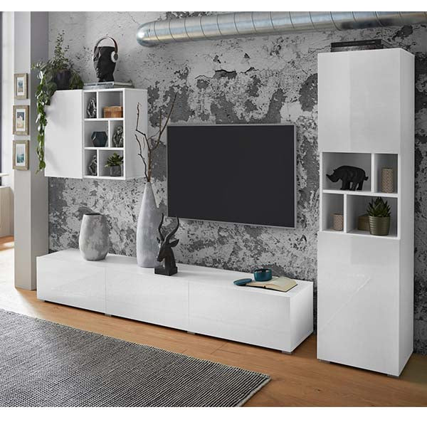 A white matte TV unit set with open shelves and a flat-screen TV, placed in a room with a gray wall decor and other decorative items.