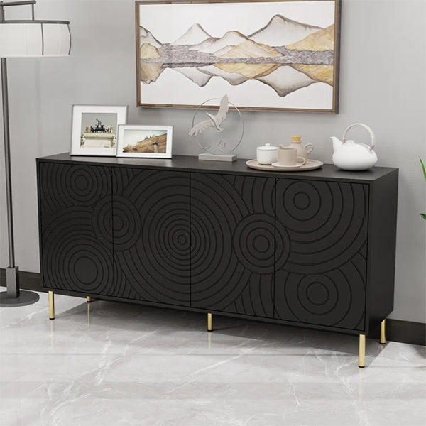 A large black sideboard with geometric patterned doors, featuring golden metal legs, placed against a wall with decorative items on top.